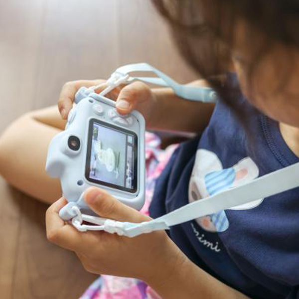 6〜8歳の子どもがキッズカメラを持っている様子